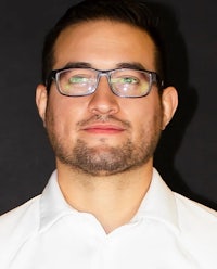 a man wearing glasses and a white shirt